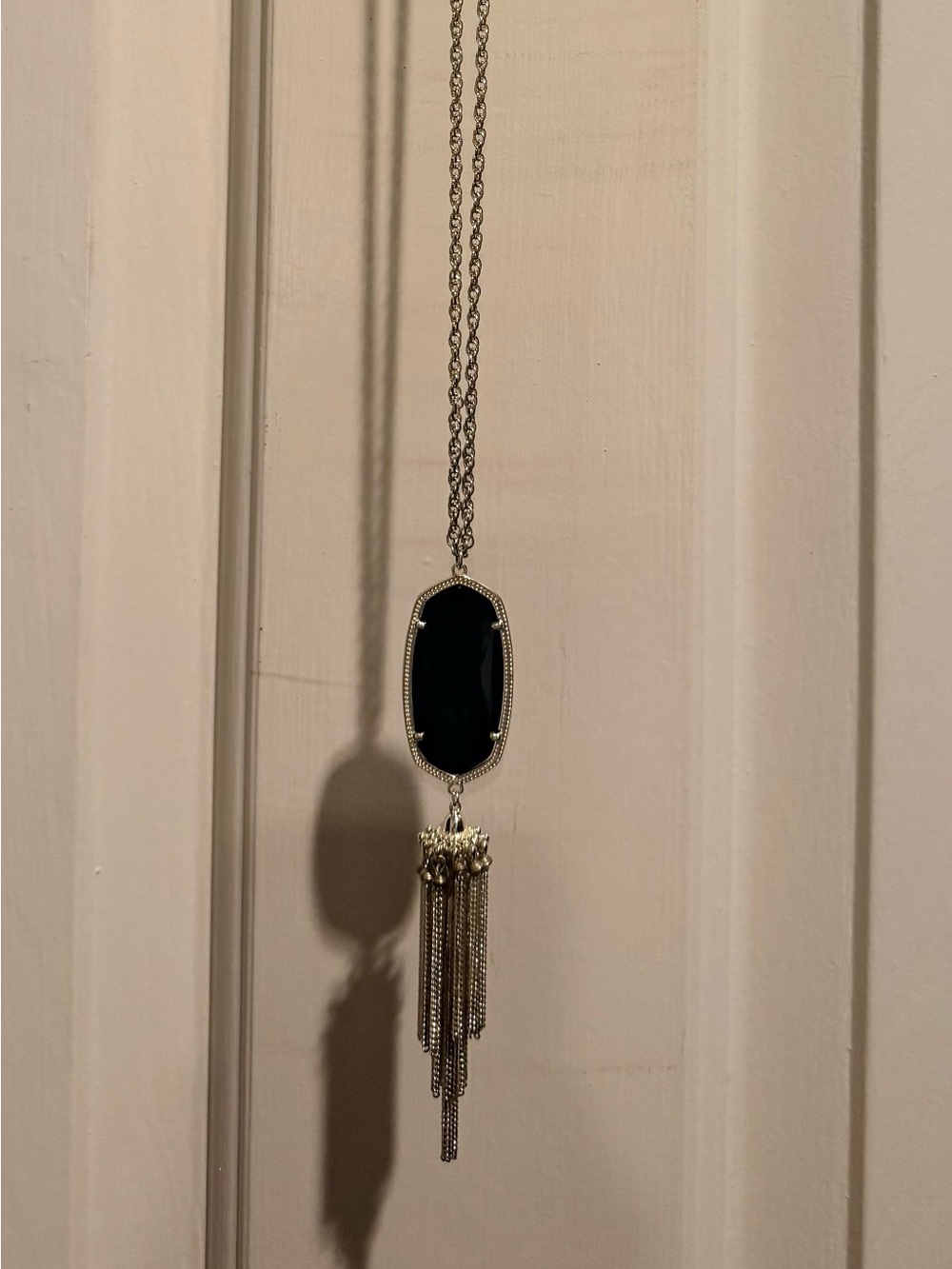 Kendra Scott Rayne long tassel gold necklace with black stone.